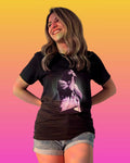 Model is wearing a black Tame Impala t-shirt with Kevin Parker in a purple filter with a dotted circle background