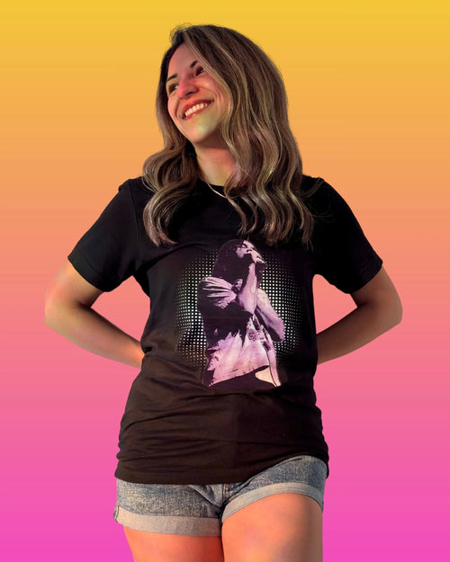 Model is wearing a black Tame Impala t-shirt with Kevin Parker in a purple filter with a dotted circle background