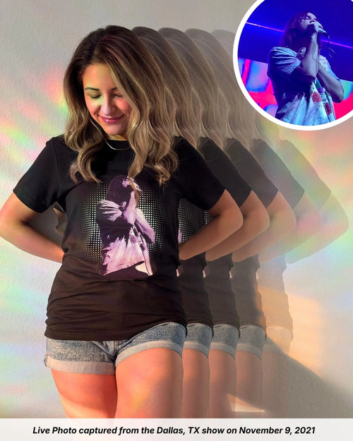 Model is wearing a black Tame Impala t-shirt with a Live Photo of Kevin Parker in a purple filter from The Slow Rush Tour in Dallas, TX on November 9, 2021. Dotted background behind Kevin.