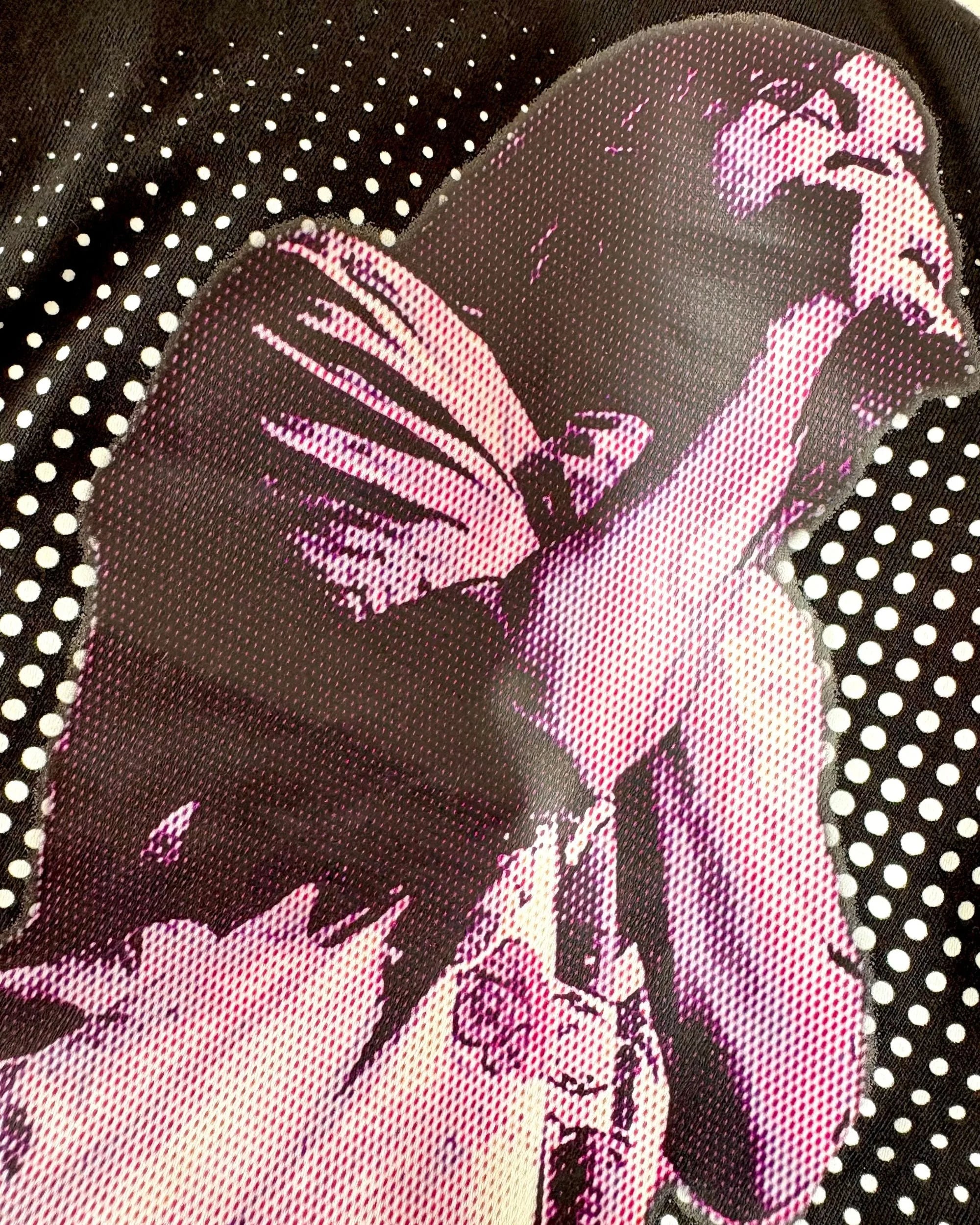 Close up of the black Tame Impala T-shirt featuring Kevin Parker in a purple filter and a dotted background