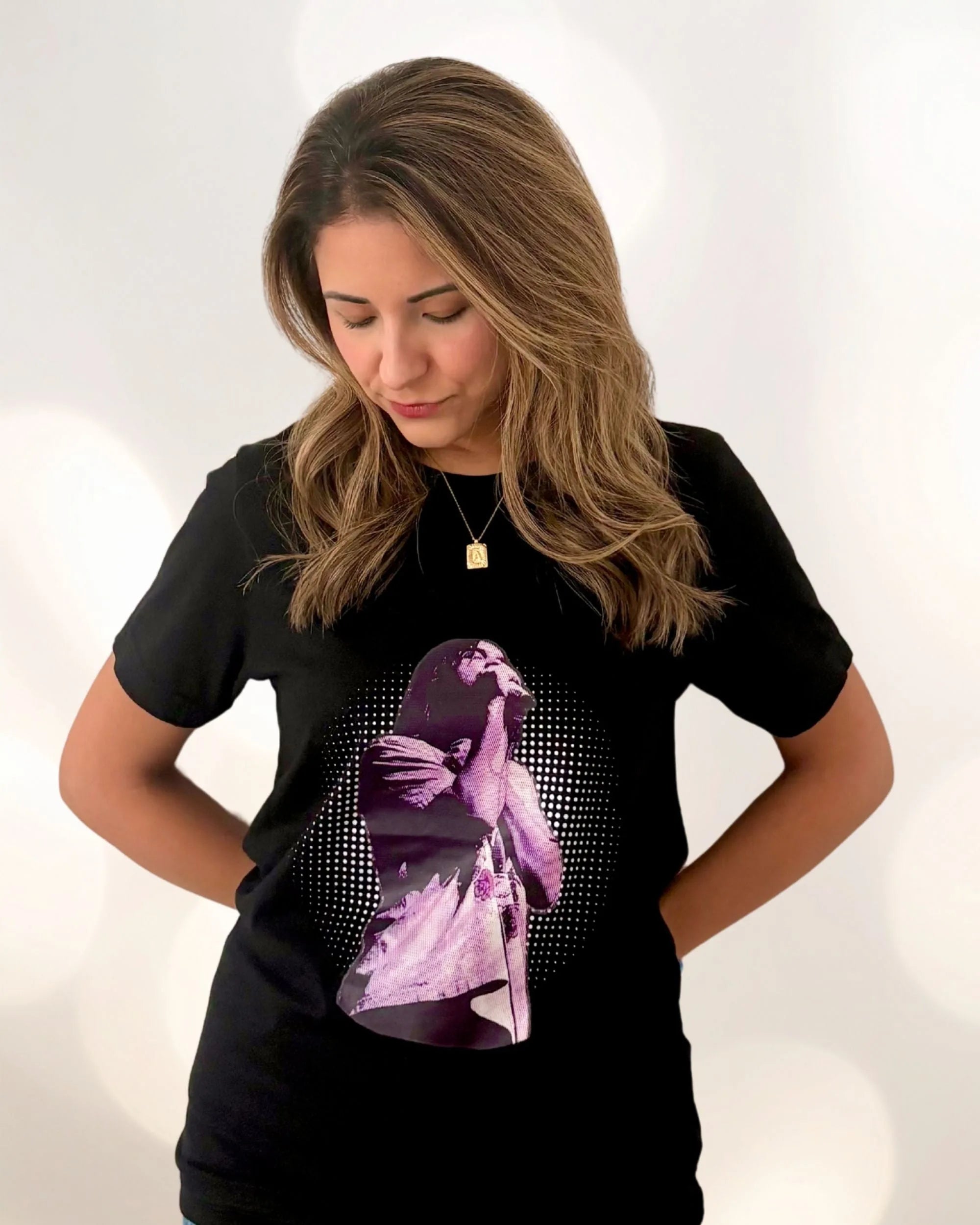 Model is wearing a black Tame Impala t-shirt with Kevin Parker in a purple filter with a dotted background